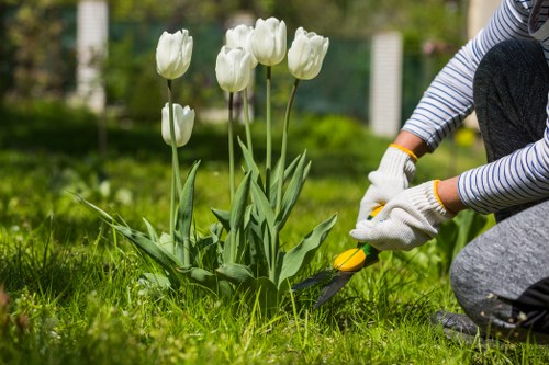 Community gardener in Poplar arranging green waste for recycling